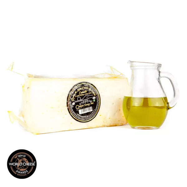Cured raw goat's milk cheese in EVOO Half cheese